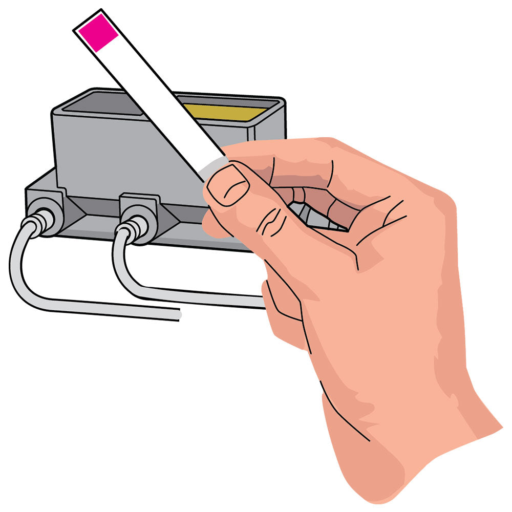 a close-up of a hand holding a single brake fluid test strip in front of a rectangular box
