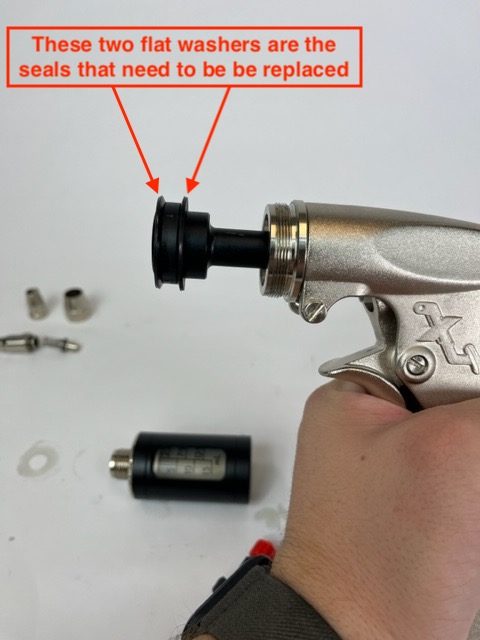 The image shows two flat circular rubber washers. The text in the image says “These two flat washers are the seals that need to be replaced”. These washers are replacement parts for the Phoenix Systems MaxPro205 plunger tool.