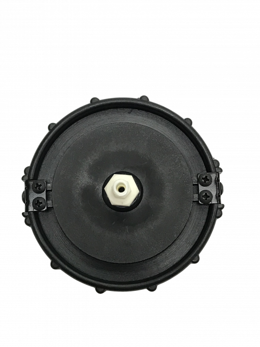 a close-up of a BC-12 Master Cylinder Cap Adapter- Honda Universal. It is a round, black object with a grooved outer edge. There is a small hole in the center of the adapter. The adapter is designed to be used on Honda vehicles to bleed the brakes.