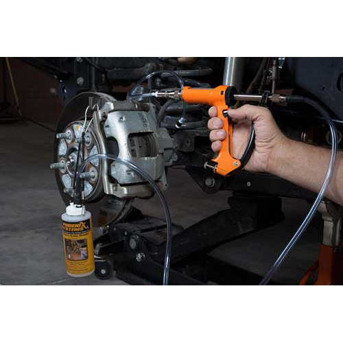 The image shows a mechanic using a brake fluid bleeding gun to bleed a brake caliper on a car.