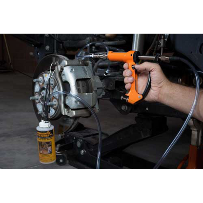 The image shows a mechanic using a brake fluid bleeding gun to bleed a brake caliper on a car.